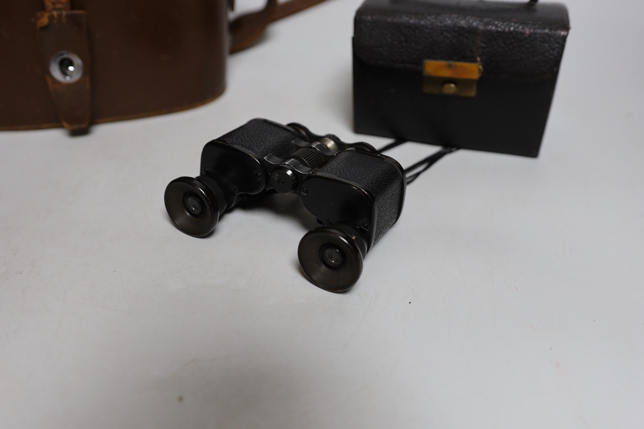 A cased set of Ross binoculars and a smaller cased set for racing